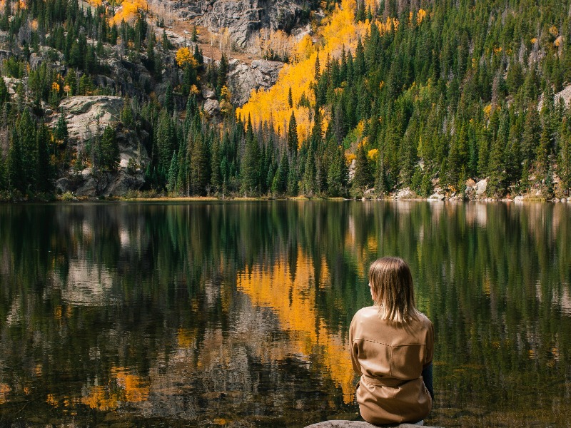 Fall in Colorado: A traveler stops for a pensive moment in Rocky Mountain National Park during fall.